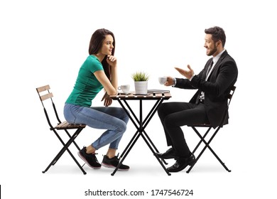 Young Woman Sitting At A Wooden Table And Talking With A Businessman Isolated On White Background