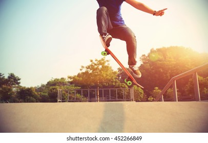 young woman skateboarder skateboarding at skatepark - Shutterstock ID 452266849