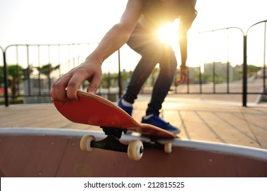 Young Woman Skateboarding At Sunrise Skatepark 