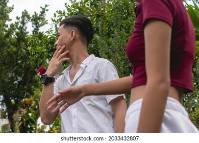 A Young Woman Slaps Her Unfaithful Boyfriend After He Is Caught Cheating Via His Cellphone. A Quarrel Occurring Outside.