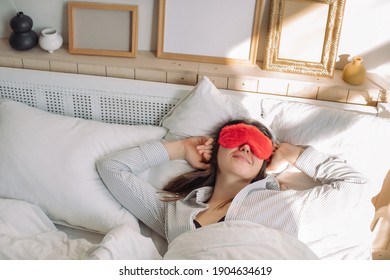 Young woman in sleep mask waking up on sunny day. ValentinesDay morning concept.