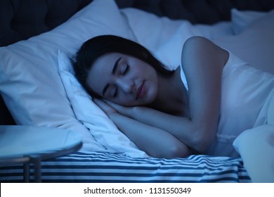 Young Woman Sleeping In Bed At Night. Sleeping Time