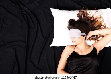 A Young Woman Sleeping With A Eye Covering Mask.