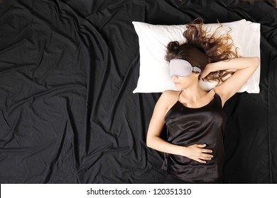 A Young Woman Sleeping With A Eye Covering Mask.