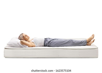 Young woman sleeping on a bed mattress isolated on white background - Powered by Shutterstock