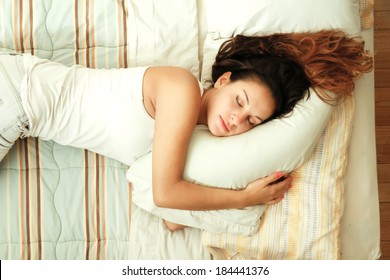 A Young Woman Sleeping On The Bed.