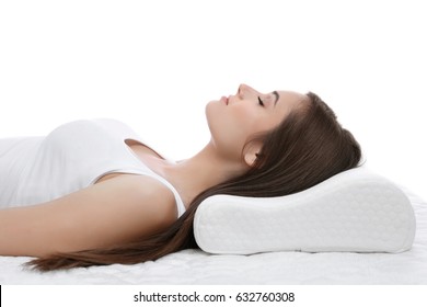 Young Woman Sleeping On Bed With Orthopedic Pillow Against White Background. Healthy Posture Concept