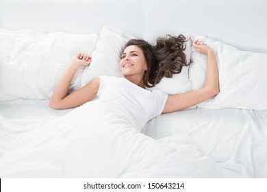 Young Woman Sleeping On The White Linen In Bed At Home, Top View