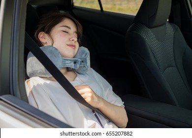 Young Woman Sleeping In A Vehicle. Spending The Night In A Car.