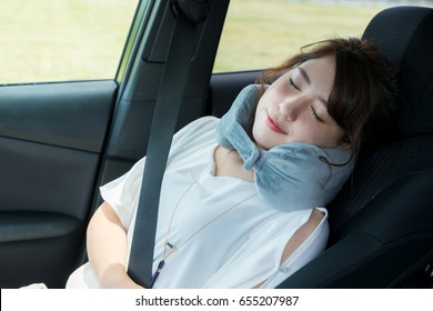 Young Woman Sleeping In A Vehicle. Spending The Night In A Car.