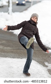 Young Woman Is Slipping And Falling On Street With Black Ice