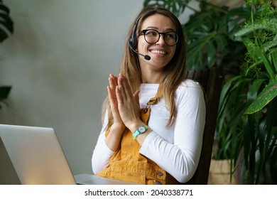 Young Woman Small Business Owner In Headset Talk With Client Or Partner Using Laptop Computer And Video Call Connection. Happy Smiling Gardener Or Florist Pass Online Webinar Courses On Home Gardening