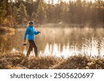 Young woman with small coffee pot in cold morning, Natural looking person in the northern forest, outdoor photo, Lapland, Finland