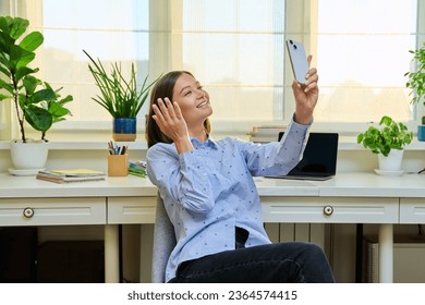 Young woman with smartphone in hands recording video blog vlog - Shutterstock ID 2364574415