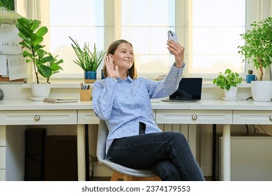 Young woman with smartphone in hands recording video blog vlog - Shutterstock ID 2374179553