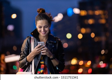 Young Woman With Smartphone At Night In A Urban City Area