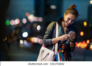 Young Woman With Smartphone At Night In A Urban City Area