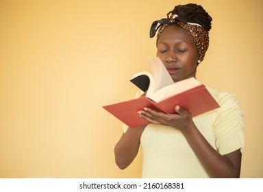 young woman smelling book pages - Shutterstock ID 2160168381