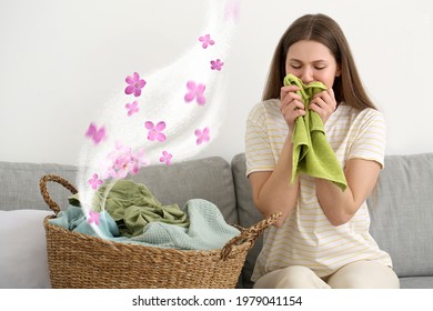 Young Woman Smelling Clean Laundry At Home