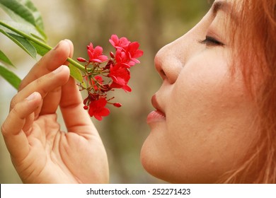  Young Woman Smelling Red Flowers