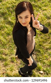 Young Woman Smile With Gesture V Sign. V For Victory Fingers Gesture Was Popularised By Winston Churchill In WW2...