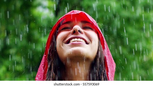 The Young Woman Smiles And Laughs Under The Rain, The Rain Drops Fall On Her Face And She Is Happy With Life And Nature Around. Concept Of Nature And Happy Life,adventure, Purity