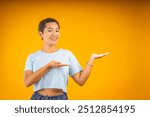 Young woman is smiling while gesturing with her hands as if she is showing something on an imaginary surface