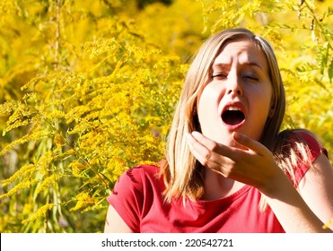 Young Woman Sneezing Because Of Ragweed Allergy.