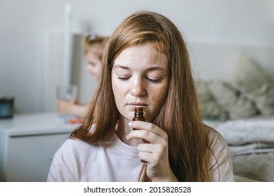 Young Woman Is Sniffing Essential Oil. Loss Of Smell And Taste From Covid