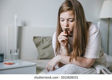 Young Woman Is Sniffing Essential Oil. Loss Of Smell And Taste From Covid