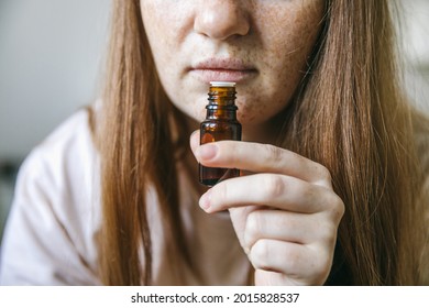 Young Woman Is Sniffing Essential Oil. Loss Of Smell And Taste From Covid