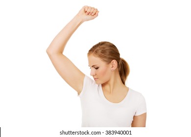 Young Woman Sniffing Her Armpit