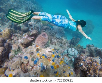 Young woman is snorkeling on a beautiful reef.