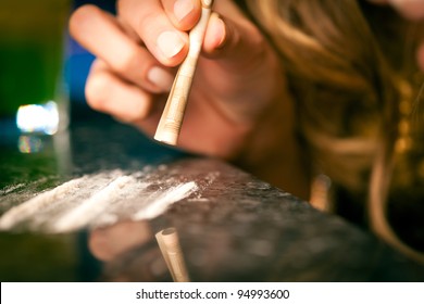 Young Woman Snorting Cocaine With A Bill, Close-up