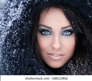 Young woman in a snowy furry hood