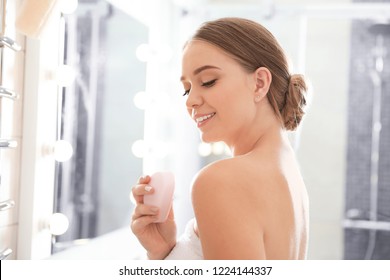 Young Woman With Soap Bar In Bathroom