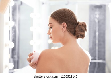 Young Woman With Soap Bar In Bathroom