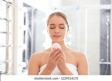 Young Woman With Soap Bar In Bathroom