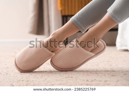 Young woman in soft slippers at home, closeup