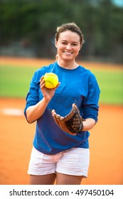 Young Woman Softball Player Pitching Ball