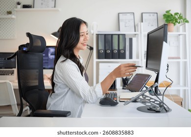 Young woman software developer working at her desk with dual screens displaying code. - Powered by Shutterstock - Get 15% off with code: PIKWIZARD15