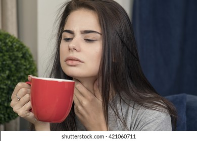 Young Woman With A Sore Throat Drinking Tea
