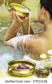 Young Woman At Spa Centre Taking Milk Bath