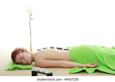 Young Woman In Spa With Rocks On Her Back, Isolated