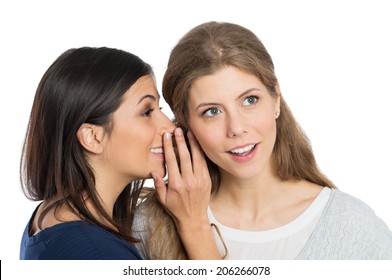 Young Woman Speak Into The Ear Into Ear Of Her Friend
