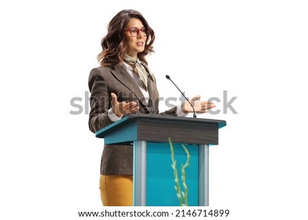Young woman speaker on a pedestal gesturing with hands isolated on white background