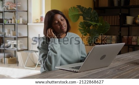 A young woman is speaking with someone on the Internet
