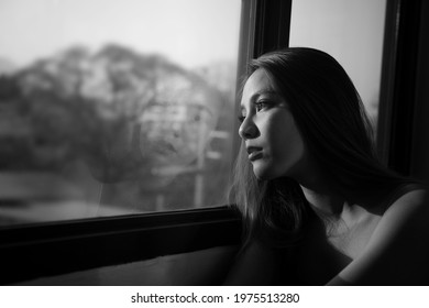 Young Woman Spending Free Time Home.Self Care,staying Home.lonely View,gazing Through To The Window.Quarantined Person Indoors.Serene Mornings.Avoiding Social Contact. Photo Black And White