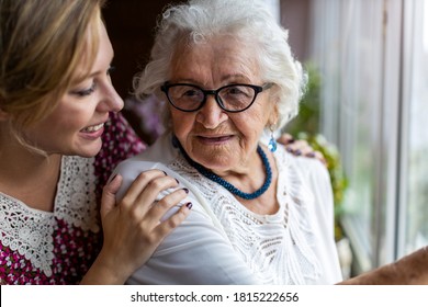 Young woman spending time with her elderly grandmother at home
