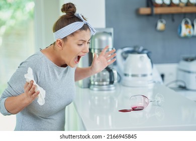 Young Woman And Spilled Wine In The Kitchen